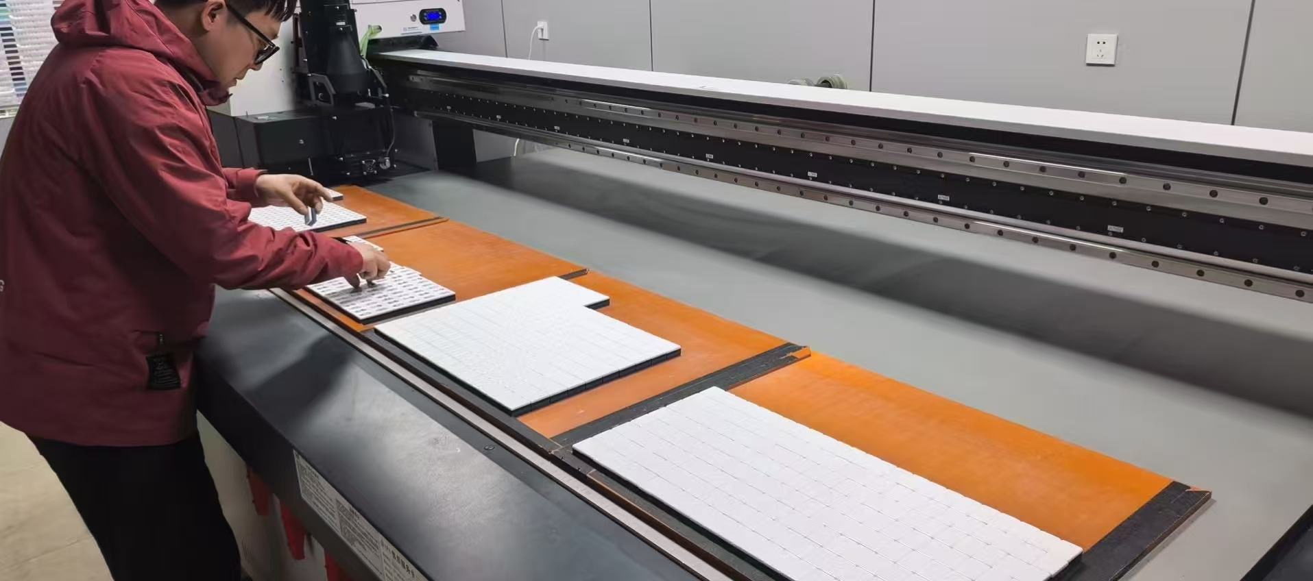 Worker arranging Mahjong tile blanks during production